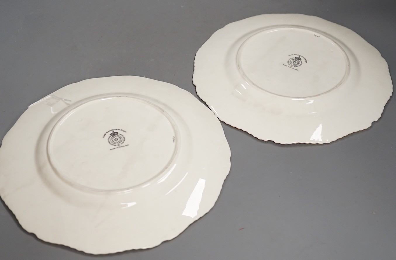 A pair of Royal Worcester fruit painted dinner plates, post war, by D. Shinnie and T. Nutt, 27cm diameter